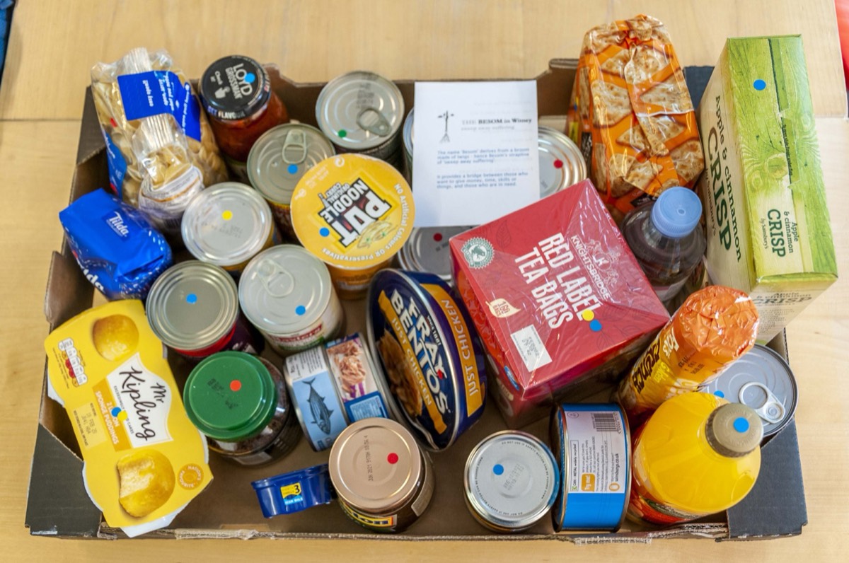 A box of donated tins, tea, cereal and other dry food
