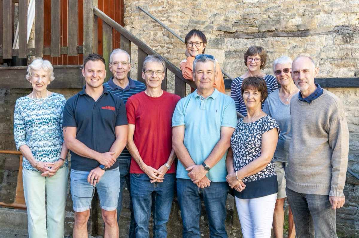The Besom in Witney team standing together outside a Cotswold stone building
